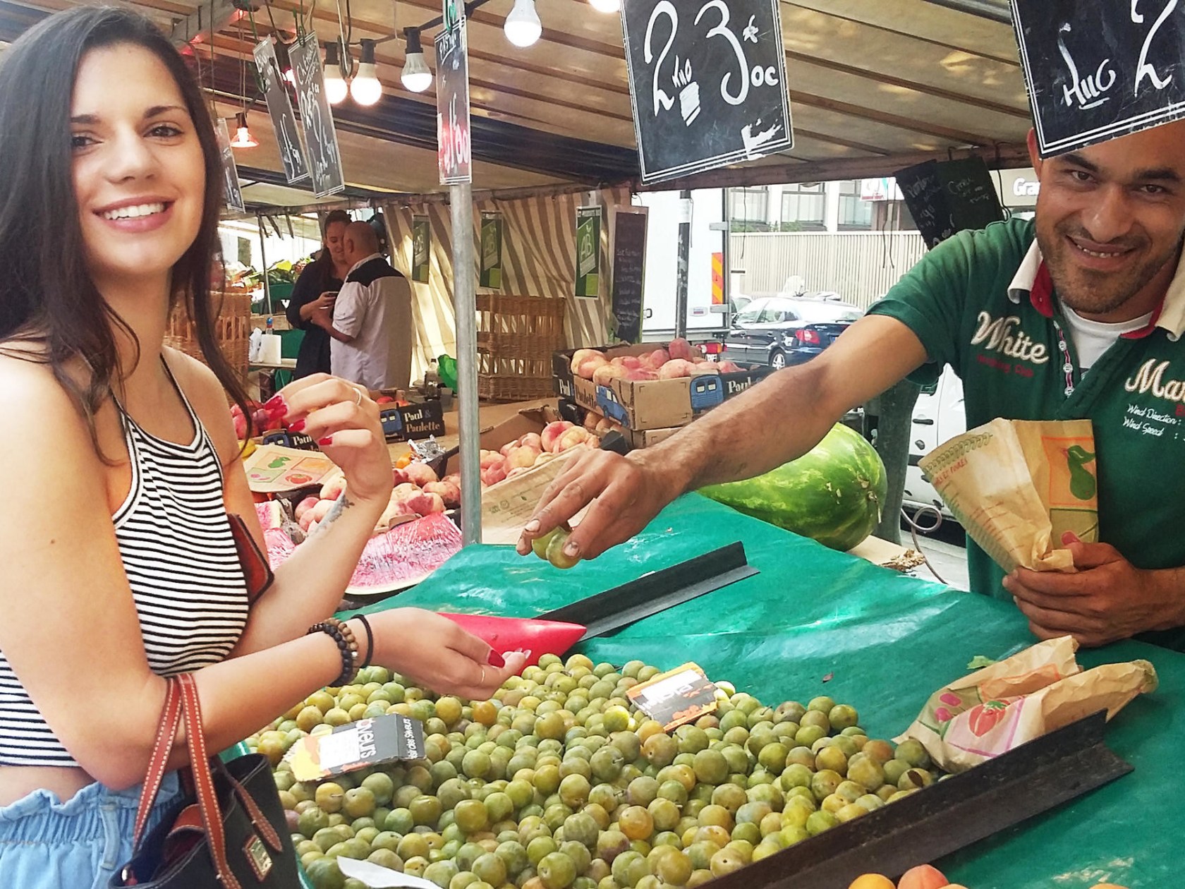 French girl getting fruit at a market