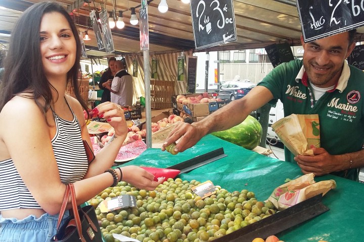 French girl getting fruit at a market