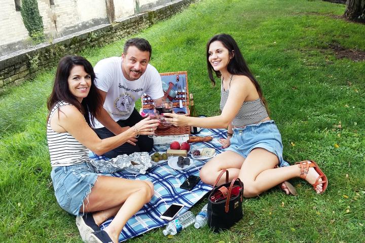 Milan and two women having a picnic