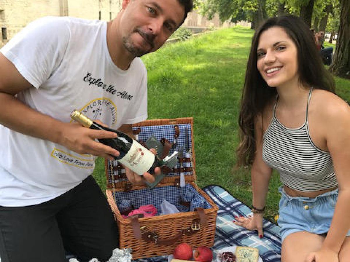 Milan showing wine bottle to young woman