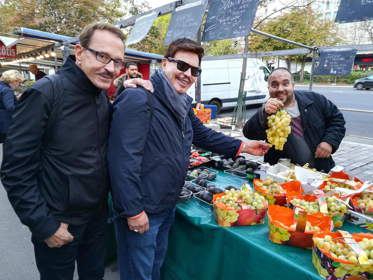 Two men purchasing Grapes