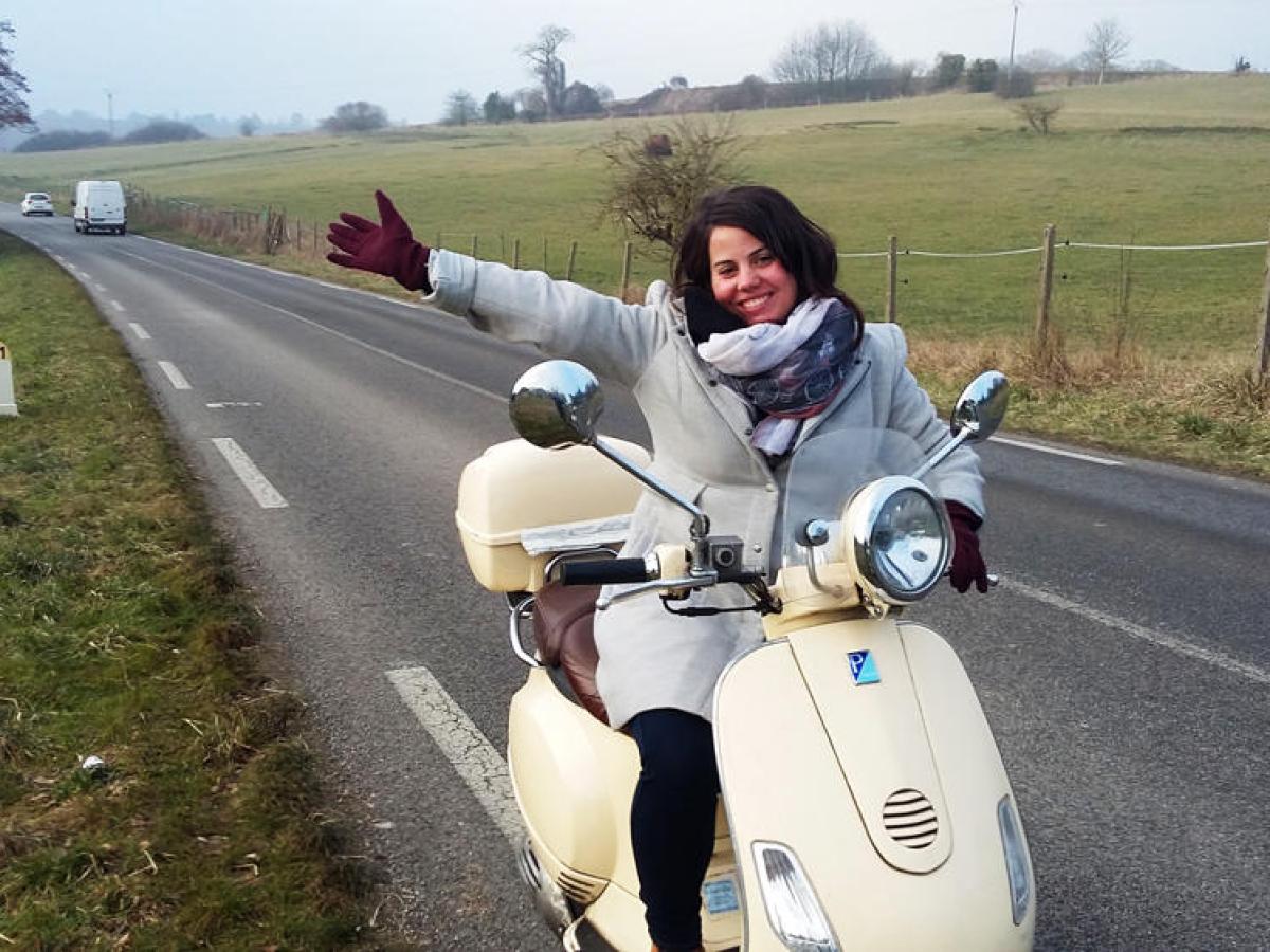 Woman on a Vespa in the countryside
