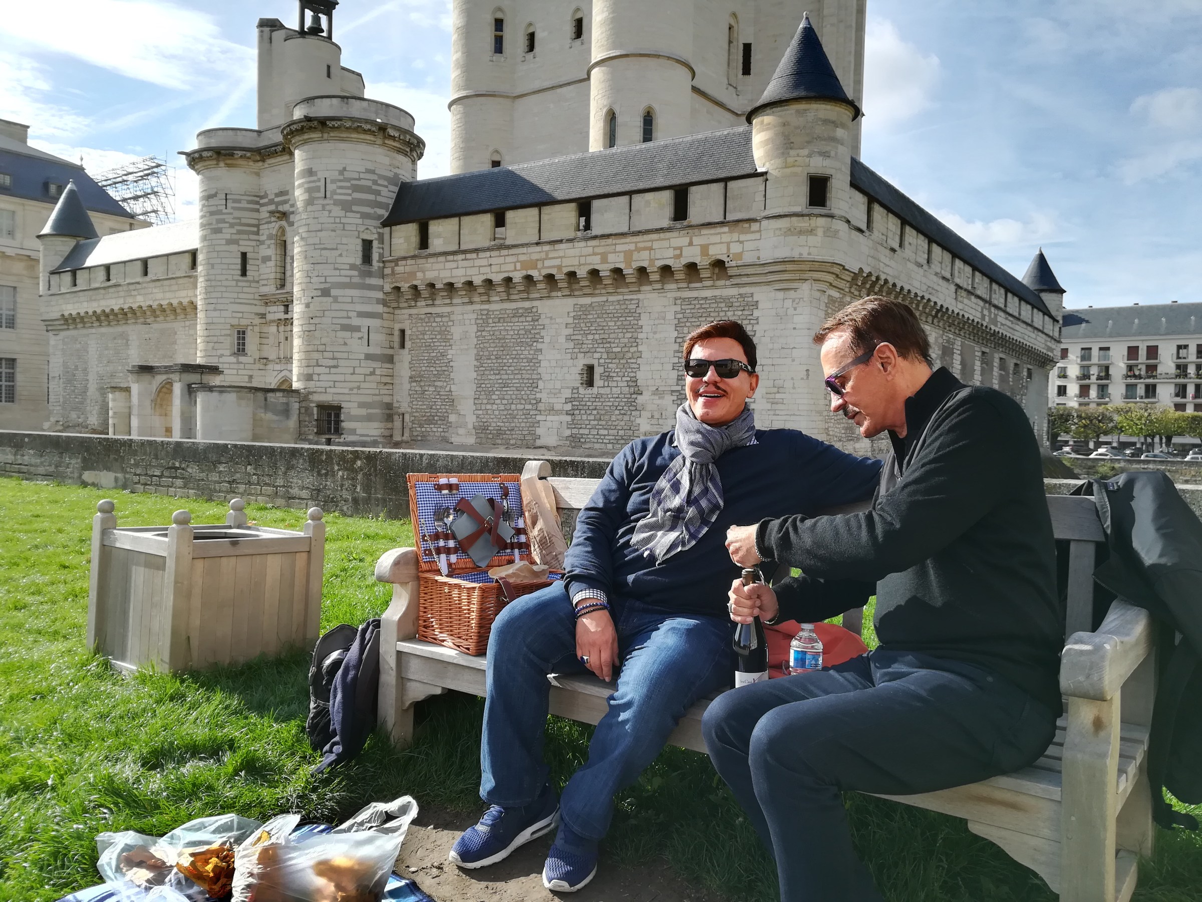 Couple sitting on a bench having a picnic